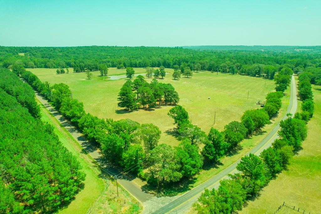 OWN A PIECE OF RANCHING HISTORY! Welcome to your dream property in Anderson County, TX, where the possibilities are limitless with this magnificent piece of Texas real estate. This 56.30-acre tract is the first property to be sold off the area’s historical 7-7 Ranch. Whether you envision creating your own ranching paradise, establishing a peaceful retreat, or developing a charming homestead – this property has the space, ambience, and flexibility to fulfill your dreams. If it's that perfect homestead you are searching for, this property has multiple homesites. The area is noted for an abundance of wildlife and this property has a perfect spot for deer hunting. This tract is complete with beautiful large shade trees, one lake and one pond to water livestock or stock for fishing. The property is fenced and cross-fenced, with sorting pens near the front of the property. A very unique feature is that is property has 1,200' of road frontage on FM 323 and 2,000' on ACR 1224.