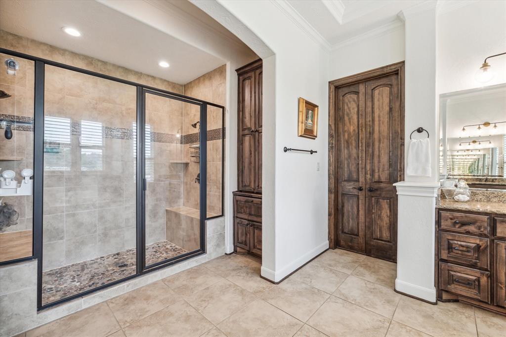 The oversized shower has two shower heads and two bench seats