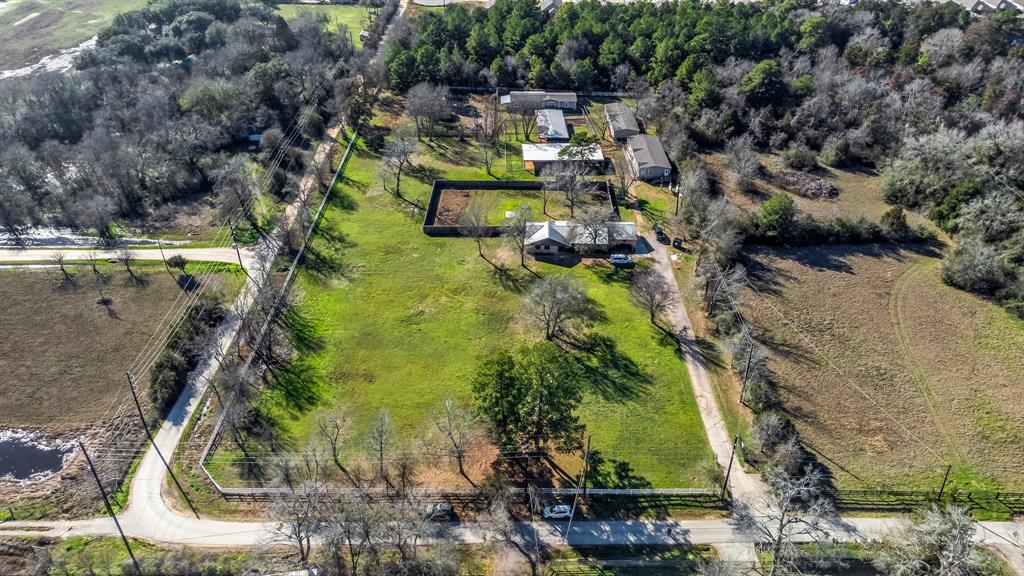 So many possibilities with this wonderful acreage in prime Tomball location close to highways and town. See our additional on-line video or QR code in our documents for drone aerial video footage.  Property boasts two covered arenas with grassy areas, cross-fencing, separate gated pasture area, and three modular buildings currently used to house dog rescues could be used as offices, guest houses, tack buildings, or rental properties. They range from 3-5 BR /2BA w/kitchen, laundry, living area, & A/C. Gated driveway entry to property. Main house renovated & set back from main road. Large rooms/open floor plan. New carpet and wood laminate. Kitchen and baths with granite and maple cabinetry. Primary bedroom with en-suite bath and two additional large bedrooms. Covered porch and fenced backyard separate from other outside areas. Two car garage with epoxy flooring and workshop area with separate A/C unit. Newer metal roof, double pane windows, well/septic. Easy access to area amenities.