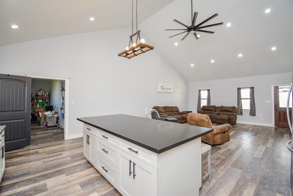 Popular sliding barn doors (left) create easy storage/room dividing access to main common areas; as seen in this wide open view from kitchen, into huge living/family space.