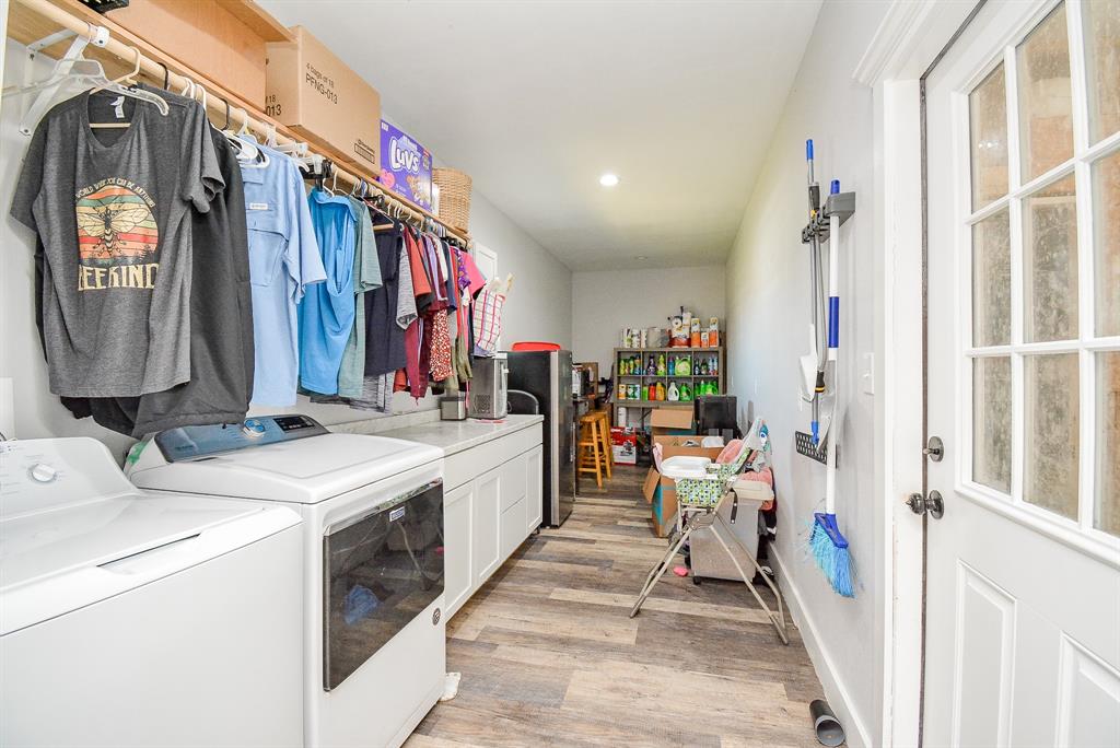 This huge utility area makes laundry days a breeze; with appliances, counter (folding) space, and generous storage space, beyond.