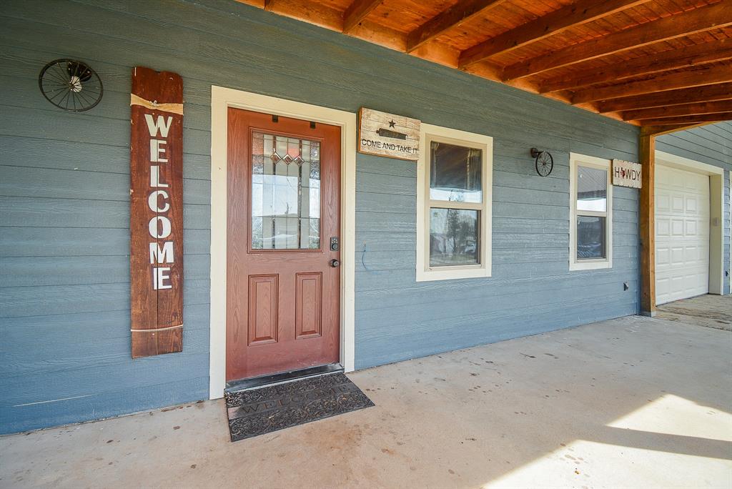 Lovely wall detail emphasizes a warm welcome, under the covered main entry.