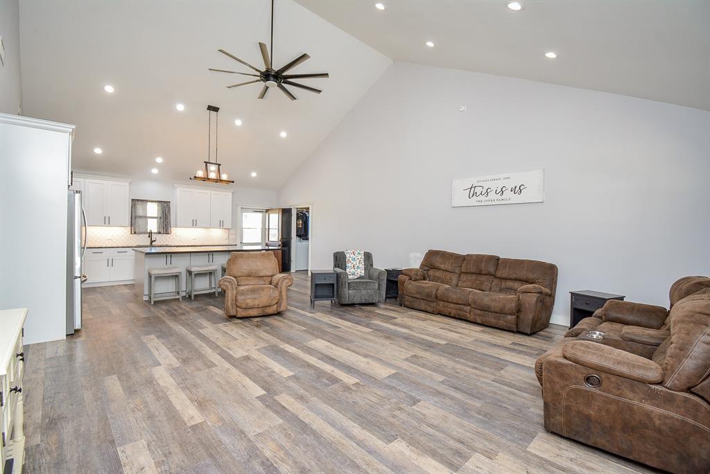 The open floor plan design concept is clearly appreciated in this huge blended living/kitchen/dining space.