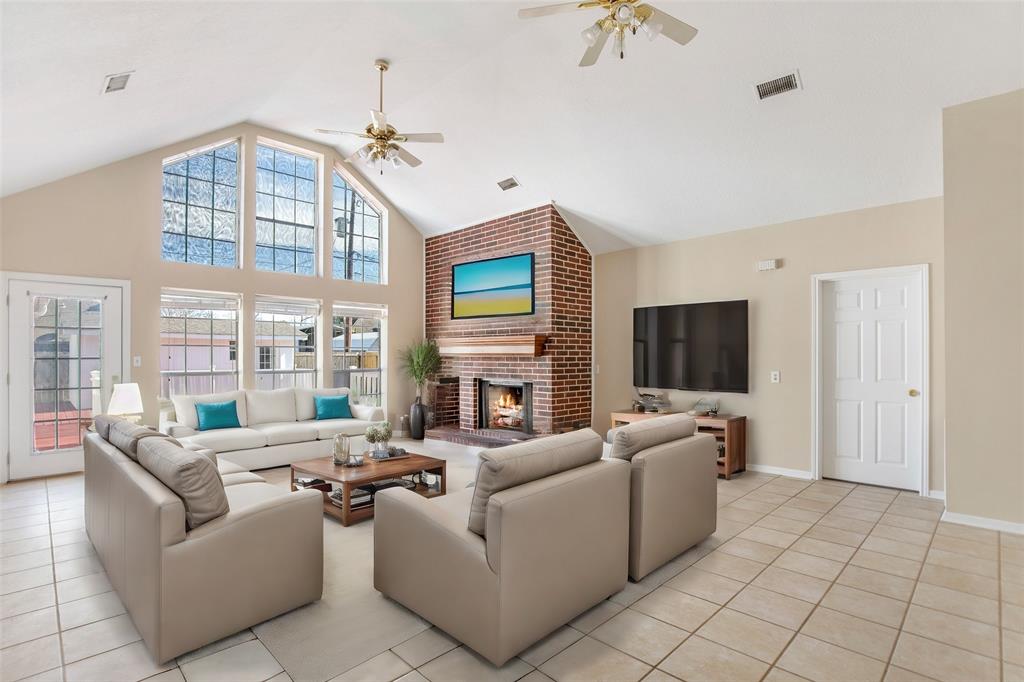 Living room with fireplace view, looking out onto the deck