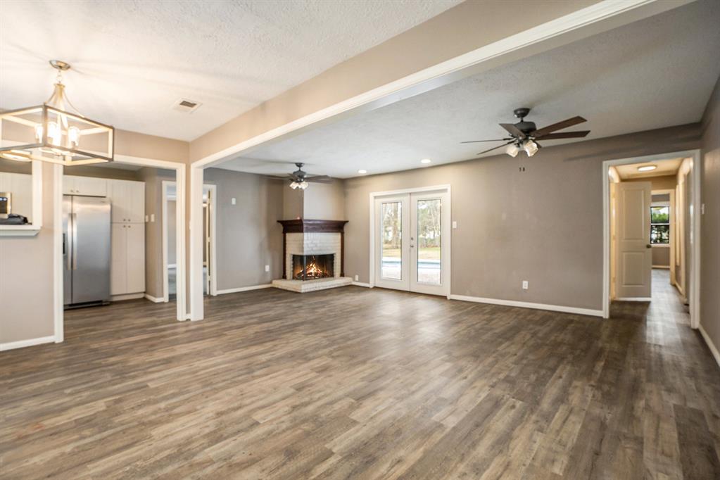 The living room has a gas fireplace with double door access to the deck and pool.