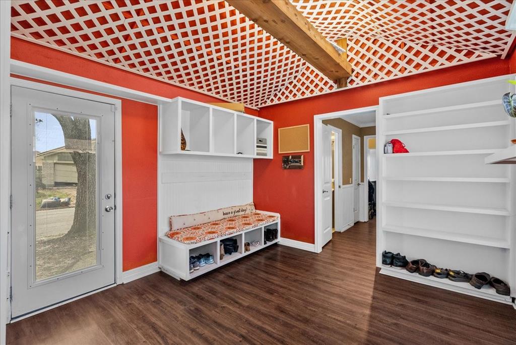 The large mudroom is a sanctuary of organization, featuring an array of shelves, cubbies, and nooks that cater to every storage need. With designated spaces for shoes, coats, bags, and outdoor gear, clutter is efficiently managed, leaving the room feeling spacious and tidy. The shelves and nooks are meticulously designed to accommodate various sizes of items, ensuring everything has its place, and the room remains a haven of orderliness.