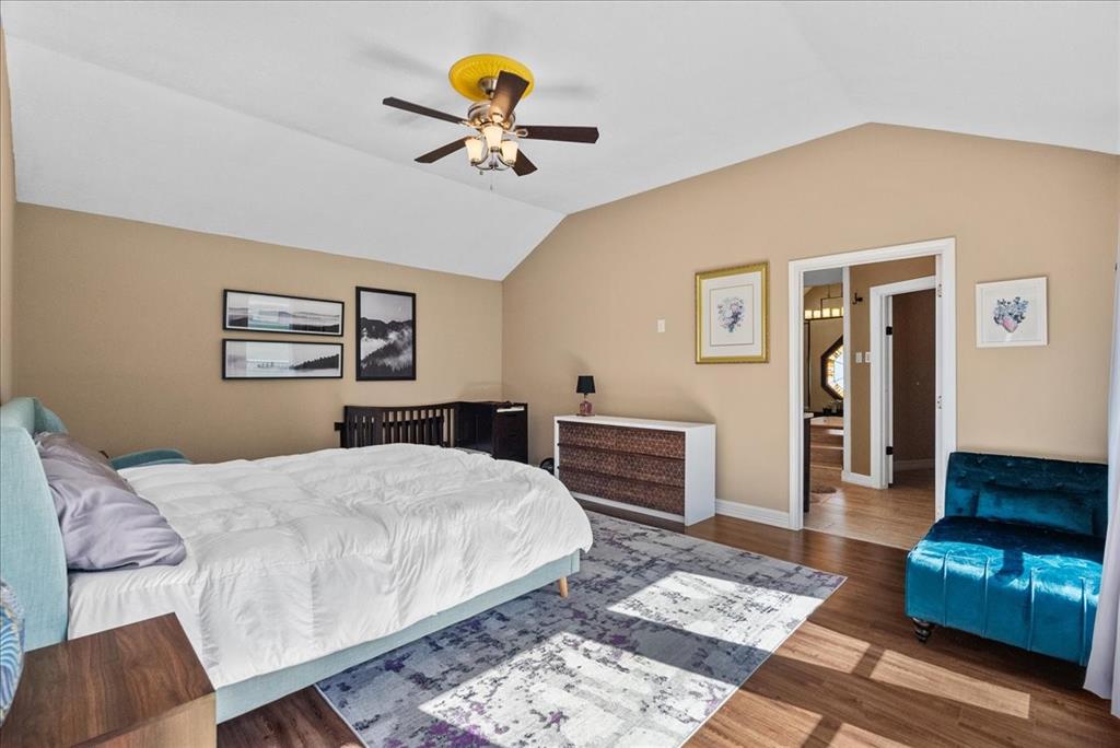 The primary bedroom is a serene retreat, flooded with natural light that filters through the floor-to-ceiling windows, creating a tranquil ambiance. The room boasts an abundance of space, so bring your Texas sized furniture.