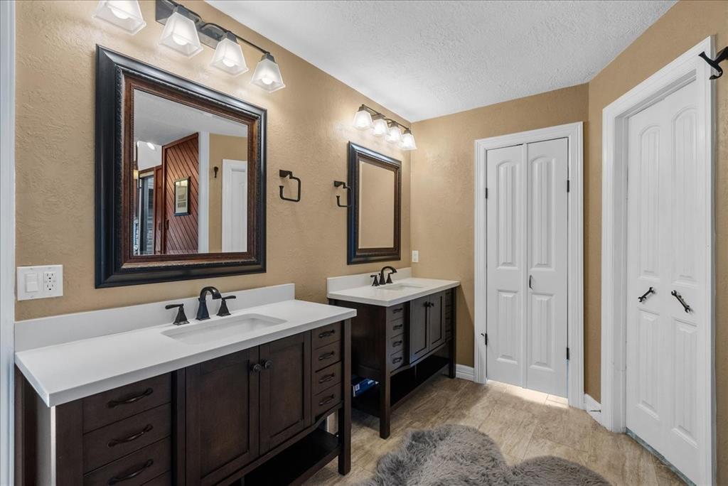 This updated primary bath features dual vanities.