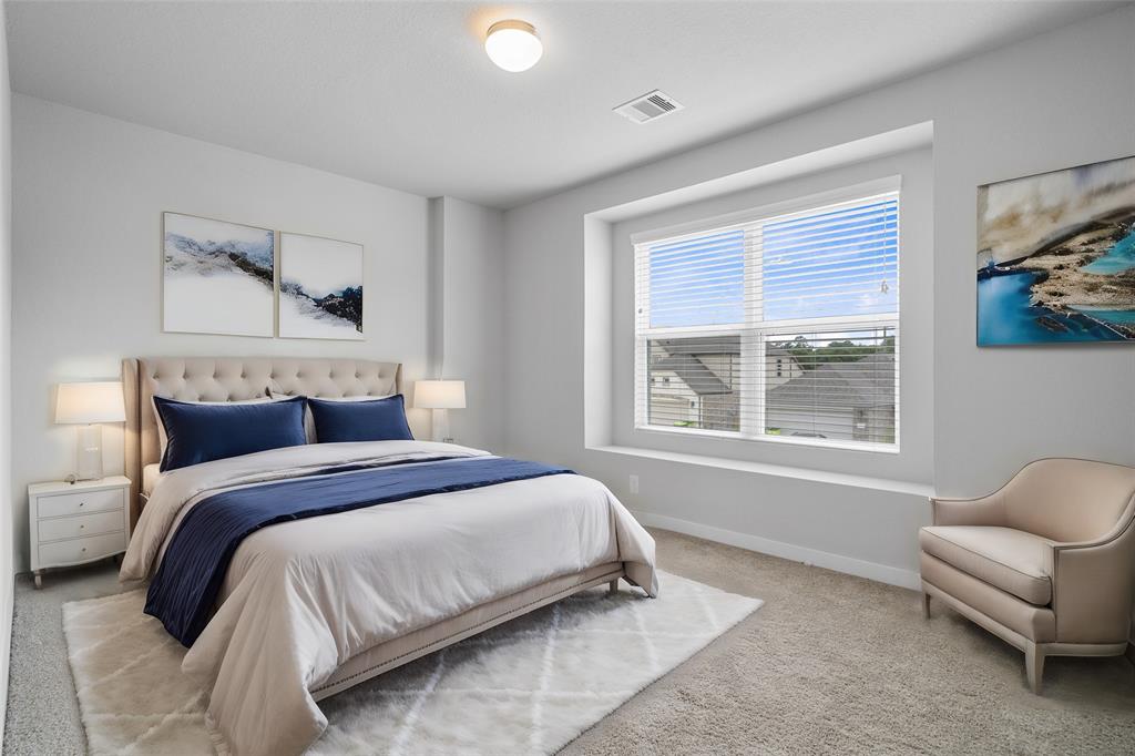 Secondary bedroom features plush carpet, custom paint and a plenty of windows allowing natural light to come in.