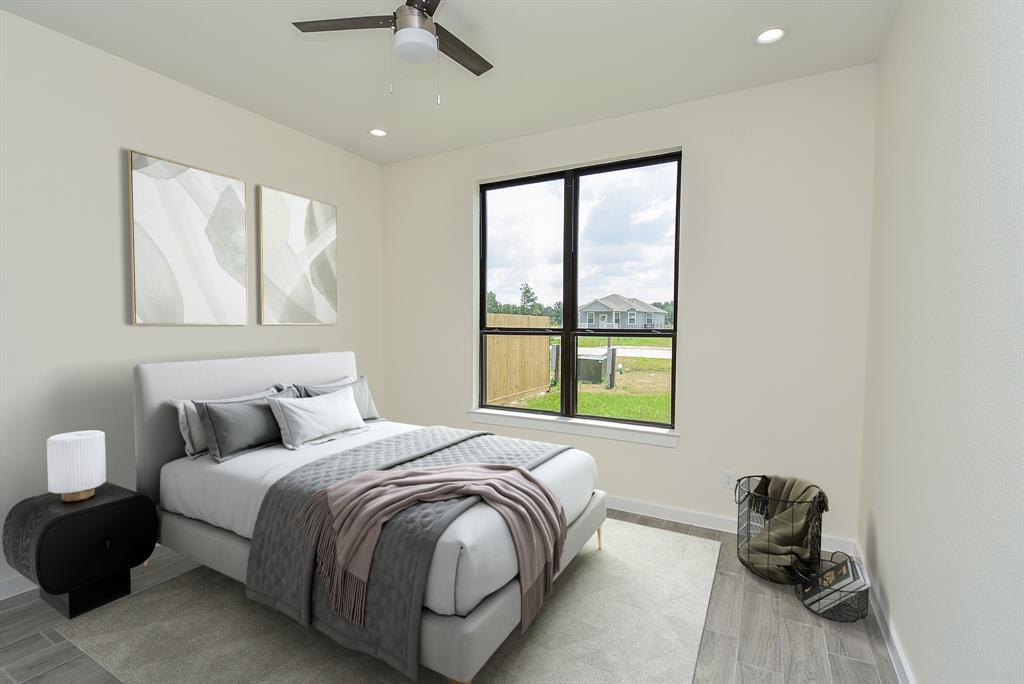 View of the first secondary bedroom featuring a ceiling fan, fantastic natural light, ample closet and access to a shared bath.