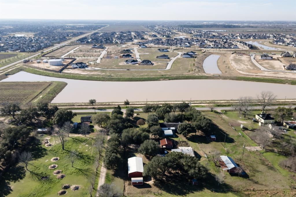 Amazing opportunity for 9.3 acres unrestricted and  Agricultural Exemptions located in Katy, Texas 77493. This is located in the heart of ranked as one of the nation's top-selling communities. This area is developing fast with residential communities, shopping, entertainment, and more! The property is improved with a mobile home, barns, and workshop. This site would make an excellent location for an outdoor Music/BBQ venue or just about anything you want it to be. It is serviced by water wells, on-site sewage, and electricity. Many more opportunities exist, such as Flex Space/ Storage building, Townhome, or Apartment construction. Since this area has no storage or Flexible space, this can be a dream project for future buyers.