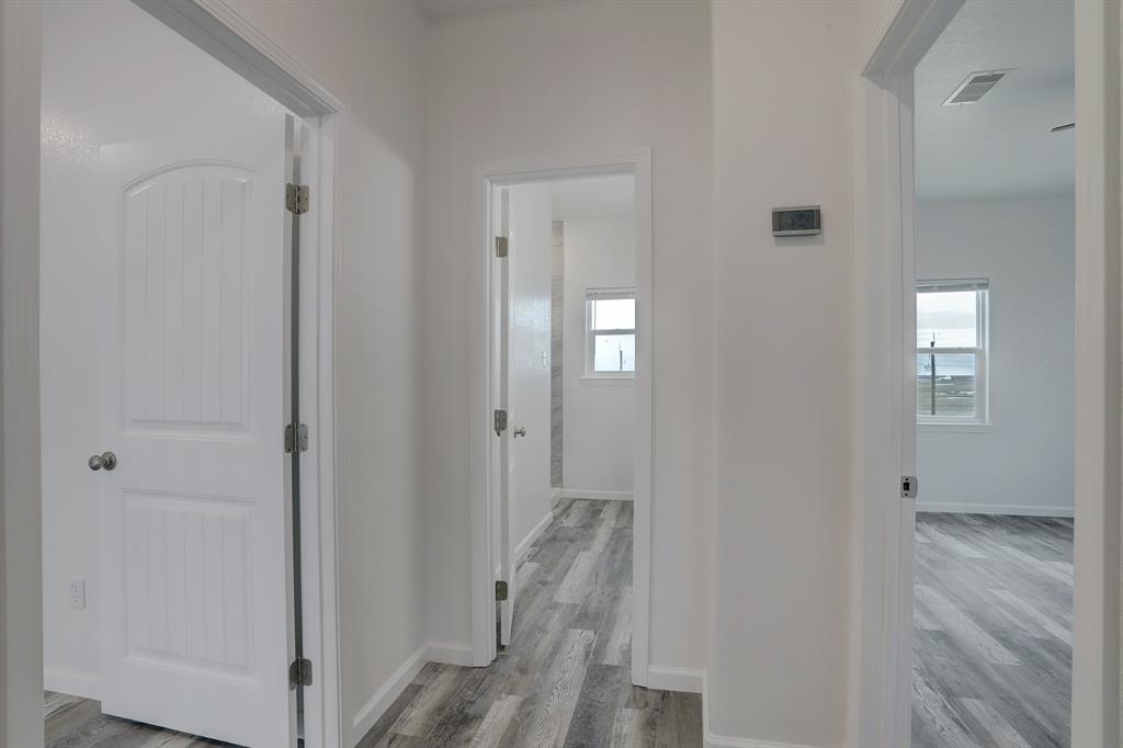 This shows the door to the primary bedroom, the hall bathroom, and the third bedroom to the right  this is a picture of an existing home like the one being built