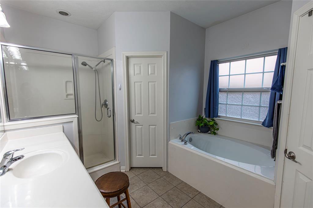 Master Bathroom with large soaking tub, walk-in shower, and his and her closets.