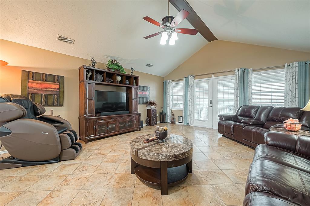 From the other end of the room, looking toward the entry doors and porch.