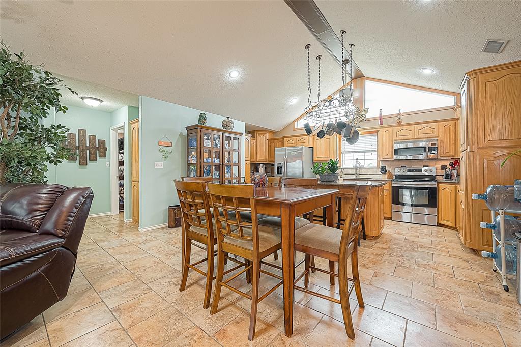 From the open dining area, looking toward the kitchen.  The primary suite entrance is off to the left.