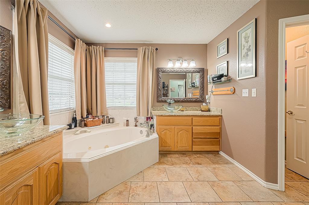 Just beyond the closet is the primary bath -- also spacious.  This bathroom checks off the must-have list: double sinks, separate big tub and shower and WC.