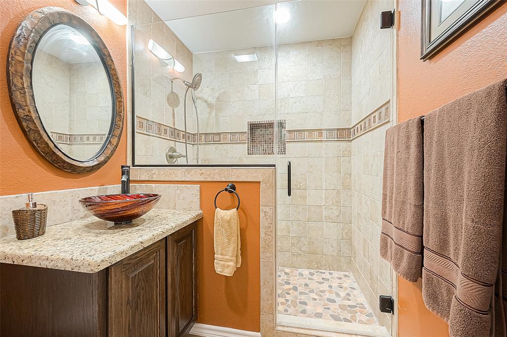 Hall bath has a beautiful shower and is located between the two secondary bedrooms.