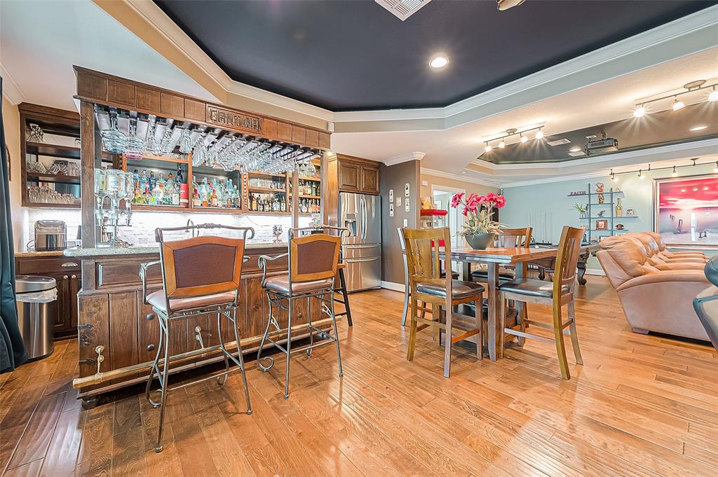 We are calling the other 29x15 area here the game room. But it includes so much! Here we can see the custom-made bar, which even has a traditional brass foot rail. There is room for a table and chairs too.