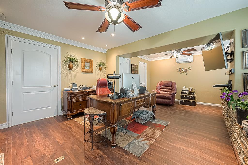 From the other end of the office/living area -- the door on the left in foreground goes into the kitchen and can be locked to separate this room from the rest of the apartment if needed, or left open to function as the apartment\'s living room. Other doors in the background go to a closet and a water heater.