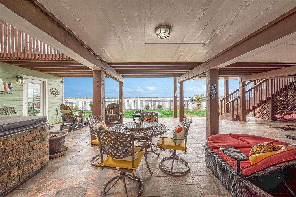 Here on the patio, you\'ll find so many possibilities for gatherings spots!  on the right are the stairs going up to the main house.  And on the left is a glass door into the studio.  The guest apartment is on the right (not shown).