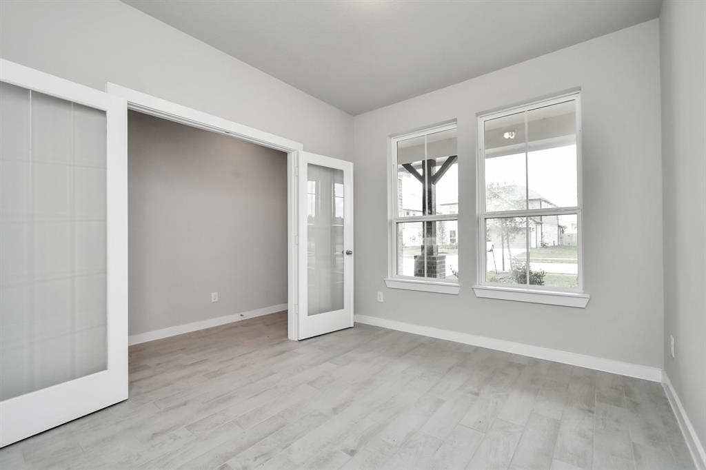 Another view of home office. Bask in the natural light pouring through the window, fostering an inspiring environment ideal for productivity and focused work.