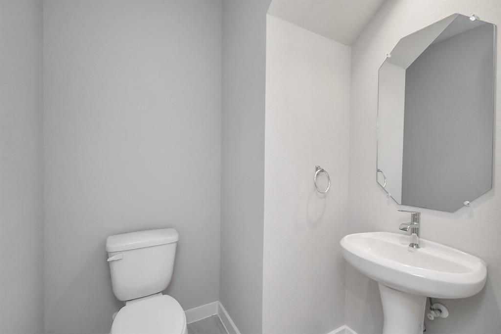 Sophisticated half bathroom adorned with contemporary finishes.