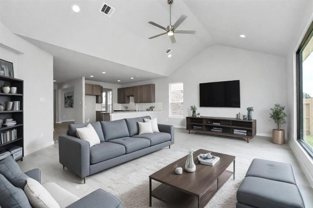 Bring the family and guests together in the welcoming family room! Enjoy the expansive space adorned with high ceilings, recessed lighting, a stylish ceiling fan, custom paint, exquisite flooring, and expansive window that fill the room with an abundance of natural light.