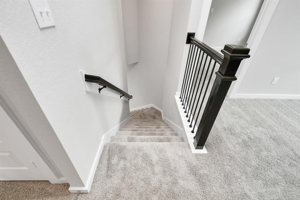 Ascend up stairs to find a game room and secondary bedrooms.