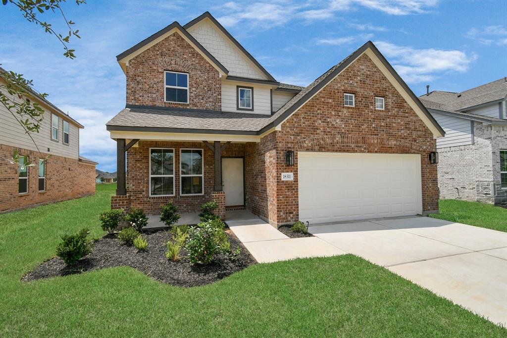 This home boasts lush green grass and meticulous landscaping. Its premium elevation showcases an exquisite blend of brick and stone features, complemented by modern coach lighting