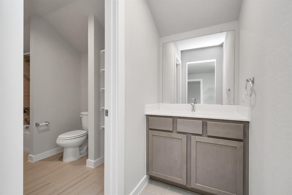 Experience convenience in the secondary bathroom, designed for Jack and Jill arrangements, now with a separate vanity area.