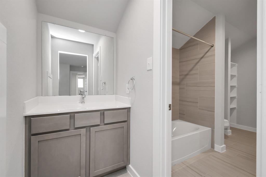 Experience convenience in the secondary bathroom, designed for Jack and Jill arrangements, now with a separate vanity area.