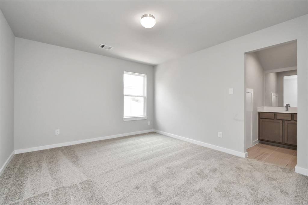 Secondary bedroom features plush carpet, custom paint, large window with privacy blinds and access to the Jack and Jill bath