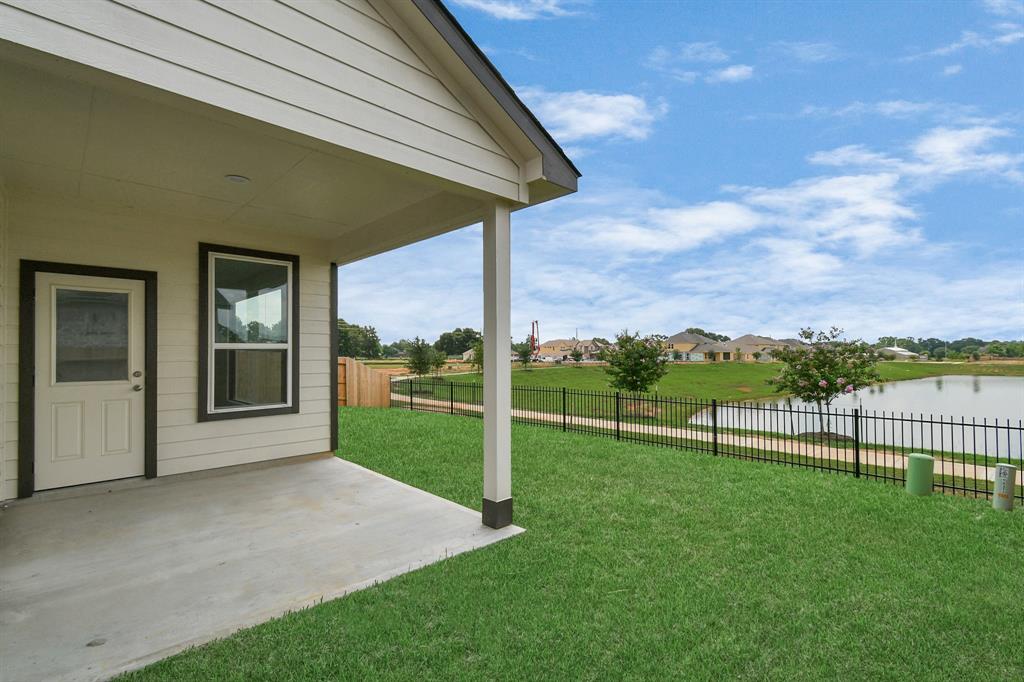 With lake views, experience outdoor living at its finest on this expansive covered patio, thoughtfully designed for BBQs and delightful outdoor dining.