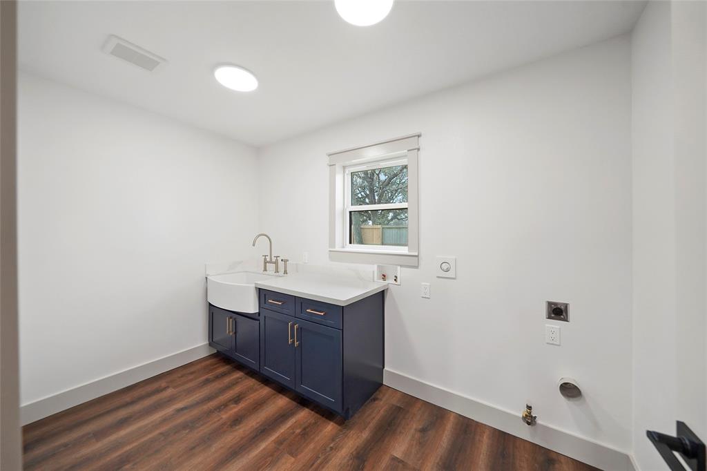 Laundry room with farmhouse sink.