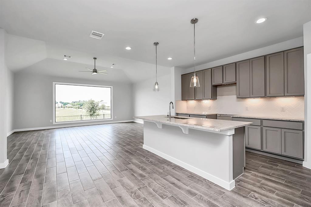 Kitchen features extended counter space, granite kitchen island with double sink, breakfast nook, and a walk-in pantry, all overlooking your huge family room.