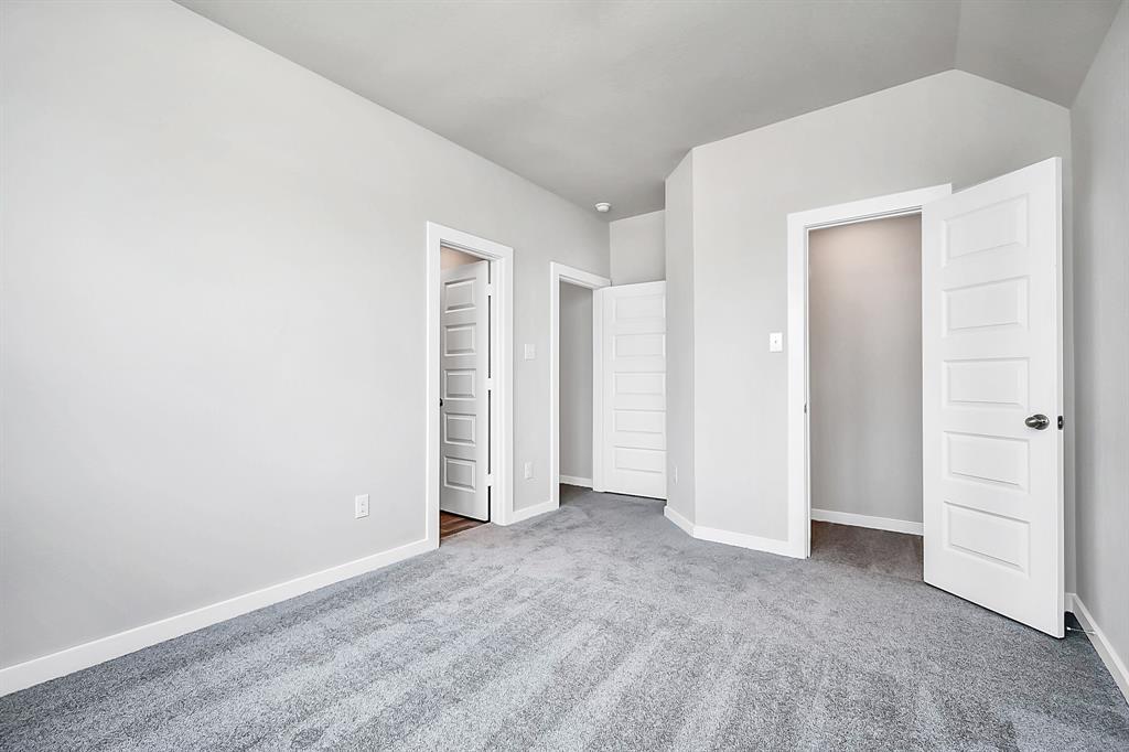 Secondary bedroom features plush carpeting, large windows that let in plenty of natural light, bright paint, and spacious closets.