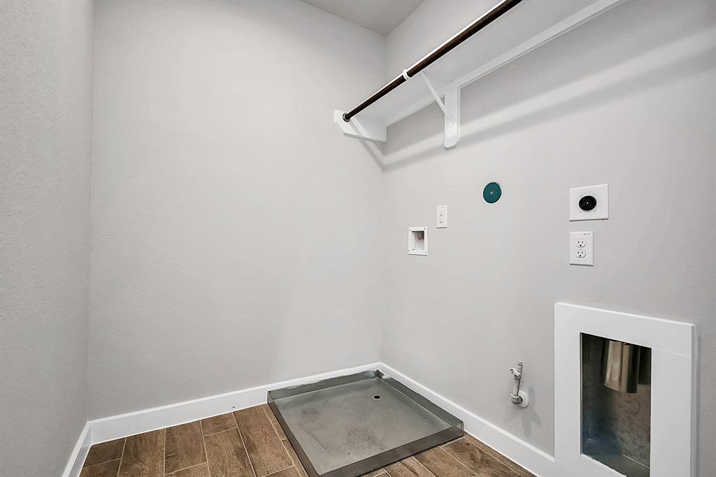 A perfect blend of functionality and comfort. Laundry room, thoughtfully equipped with shelving for effortless organization. Both gas and electric connections available