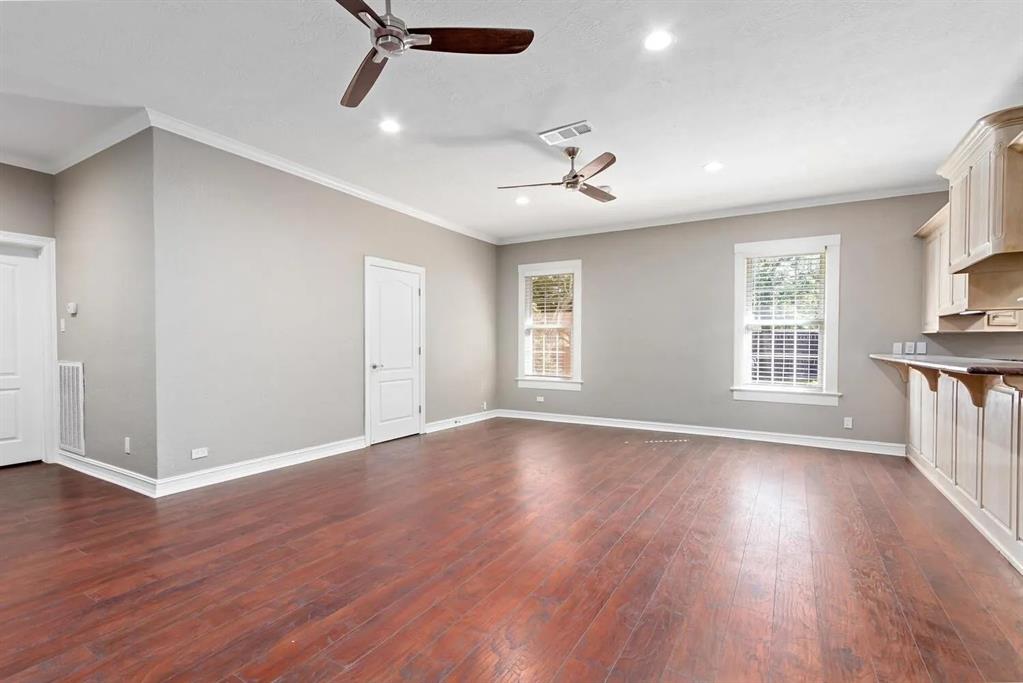 The expansive open family room and kitchen are perfect for modern living and entertaining. Natural light floods the family room, creating a bright, inviting space.