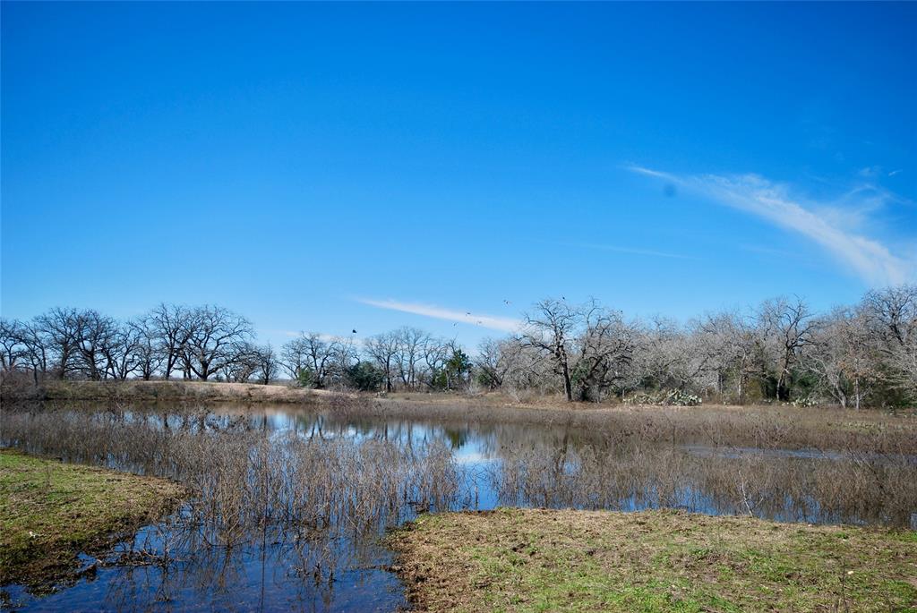 This 22.5 +/- acre tract of land is located within five minutes of Gonzales, Tx. It is mostly wooded with nice oaks and other native hardwoods but has some open areas. Build your country home  next to the pond, add a wildlife feeder nearby and enjoy the wildlife. If you are looking for a future home site that offers privacy amongst the woods, this is it. There are no pipelines on the property and it is out of the floodplain. Fenced on three sides. Livestock and horses are welcome, 4-H and FFA animals also. Excellent soil for a country garden. Great location! This tract has paved county road frontage and offers easy access to I-10. Electricity is near by. The buyer has the option of installing a private water well or having water supplied by City of Gonzales Water Works. Call and inquire about the ight restrictions that are in place to protect the value of your investment, no HOA. A new survey will be provided by the seller. Additional acreage is available.