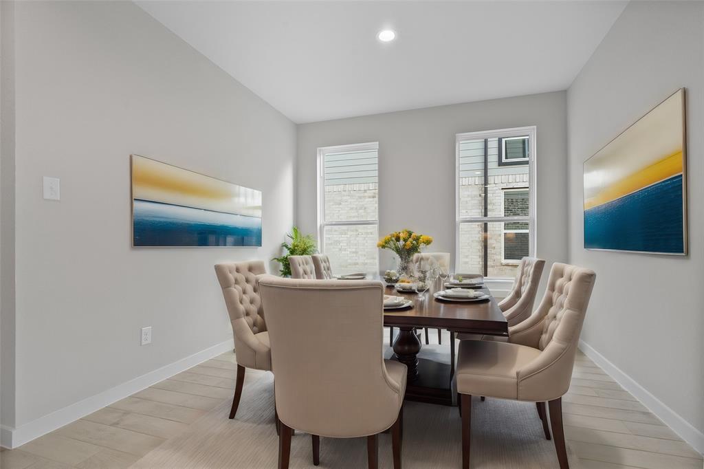 Make memories gathered around the table with your family and friends! This dining room features high ceilings, custom paint, gorgeous flooring and large windows with privacy blinds.