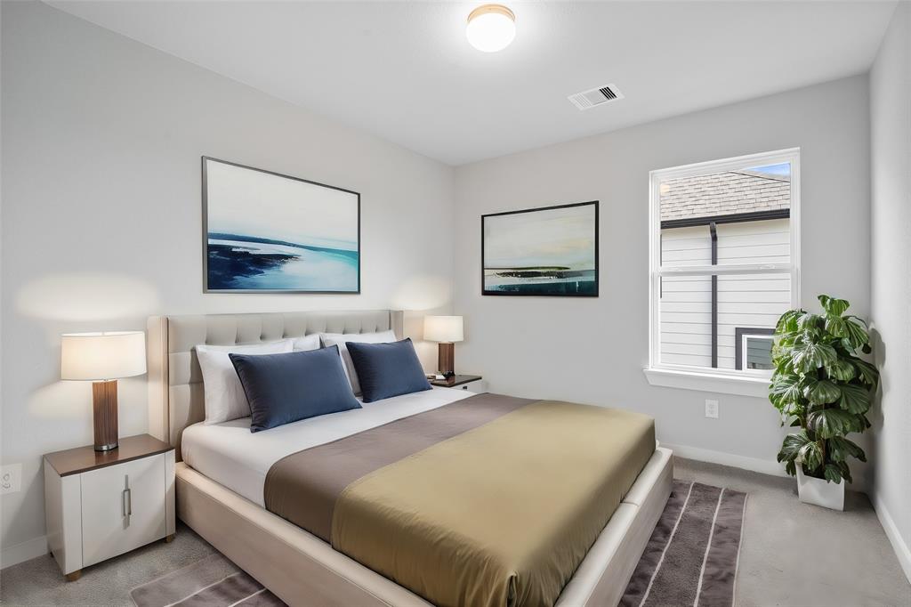 Secondary bedroom features plush carpet, custom paint, ceiling fan with lighting and a large window with privacy blinds.