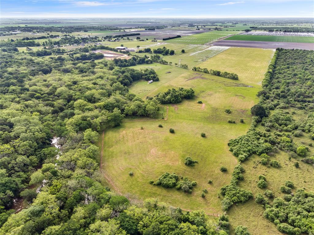 The front of the property features hard clay soil, while the back offers sandy soil along the river