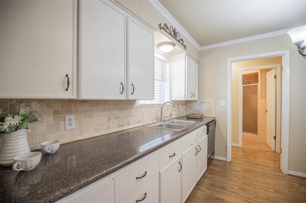 Plenty of cabinets for storage and counters for prep work. Pretty hardware matches the chandelier.