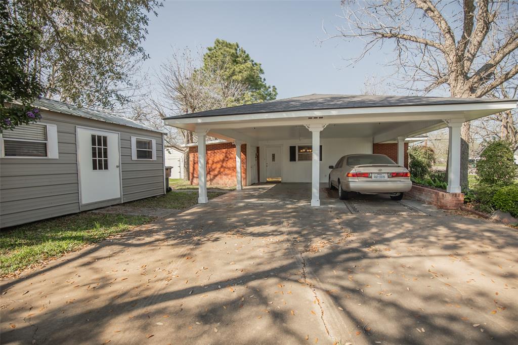 Attractive and solid posts with corbels under the carport. And notice the brick planter to the right of the car.