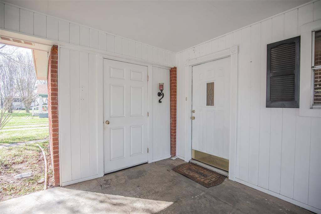 Door to the right enters the home near the kitchen. Door to the left is a extra large storage room.