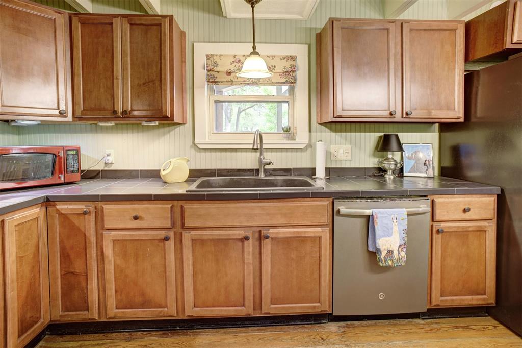 Guest bath just off the dining area in the butlers pantry also has access to the front porch