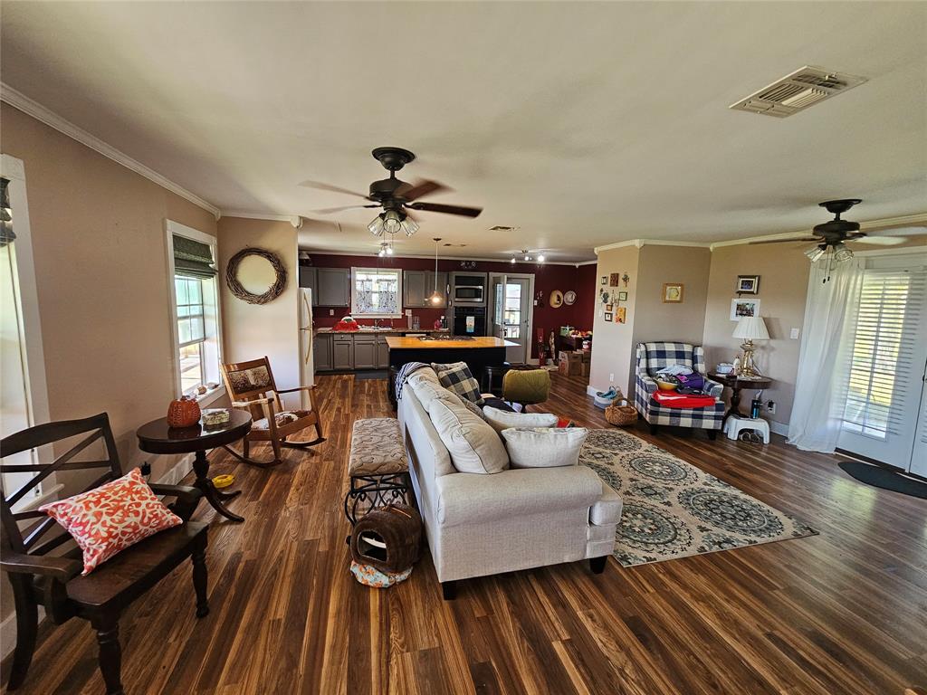 Notice French back doors to covered porch and 2 ceiling fans. Beautiful laminate floors throughout.