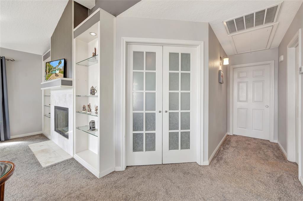 Primary suit up stairs with barn doors and ceiling fan