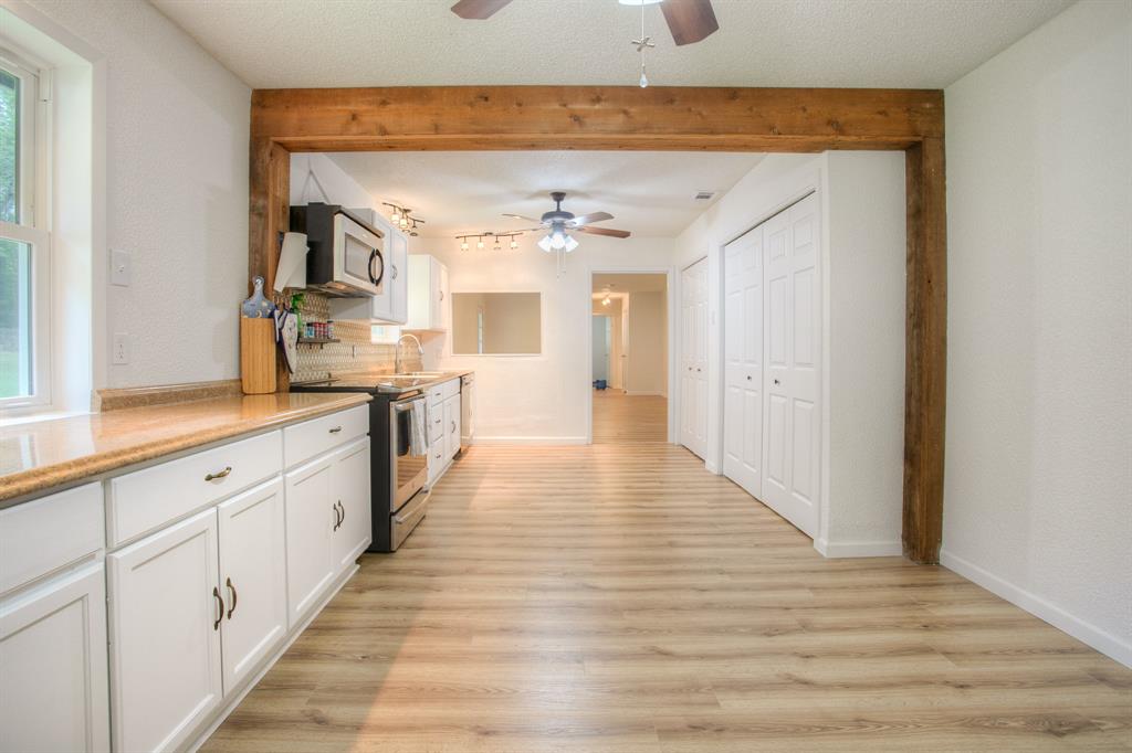 So many details, notice the high beams giving an elegant touch to this kitchen, and new flooring in the entire area