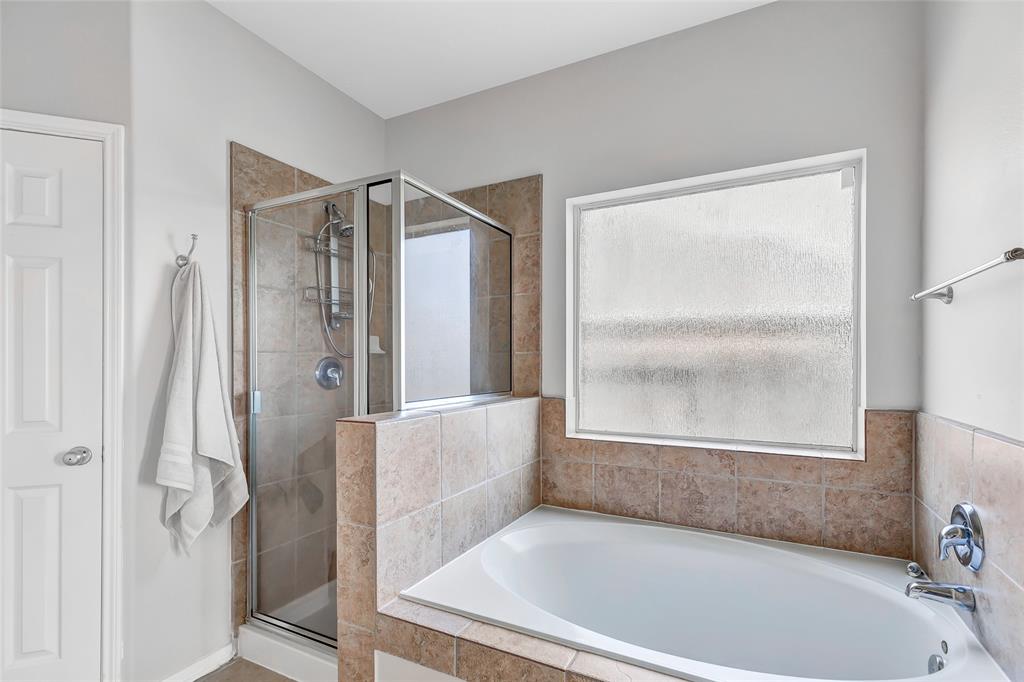 Primary bathroom with large soaking tub and separate shower